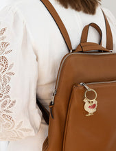 Load image into Gallery viewer, Brown leather backpack with a chicken keychain worn by a person in a white lace top.