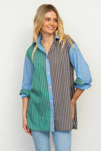 Load image into Gallery viewer, Woman wearing a colorful striped shirt with a white background